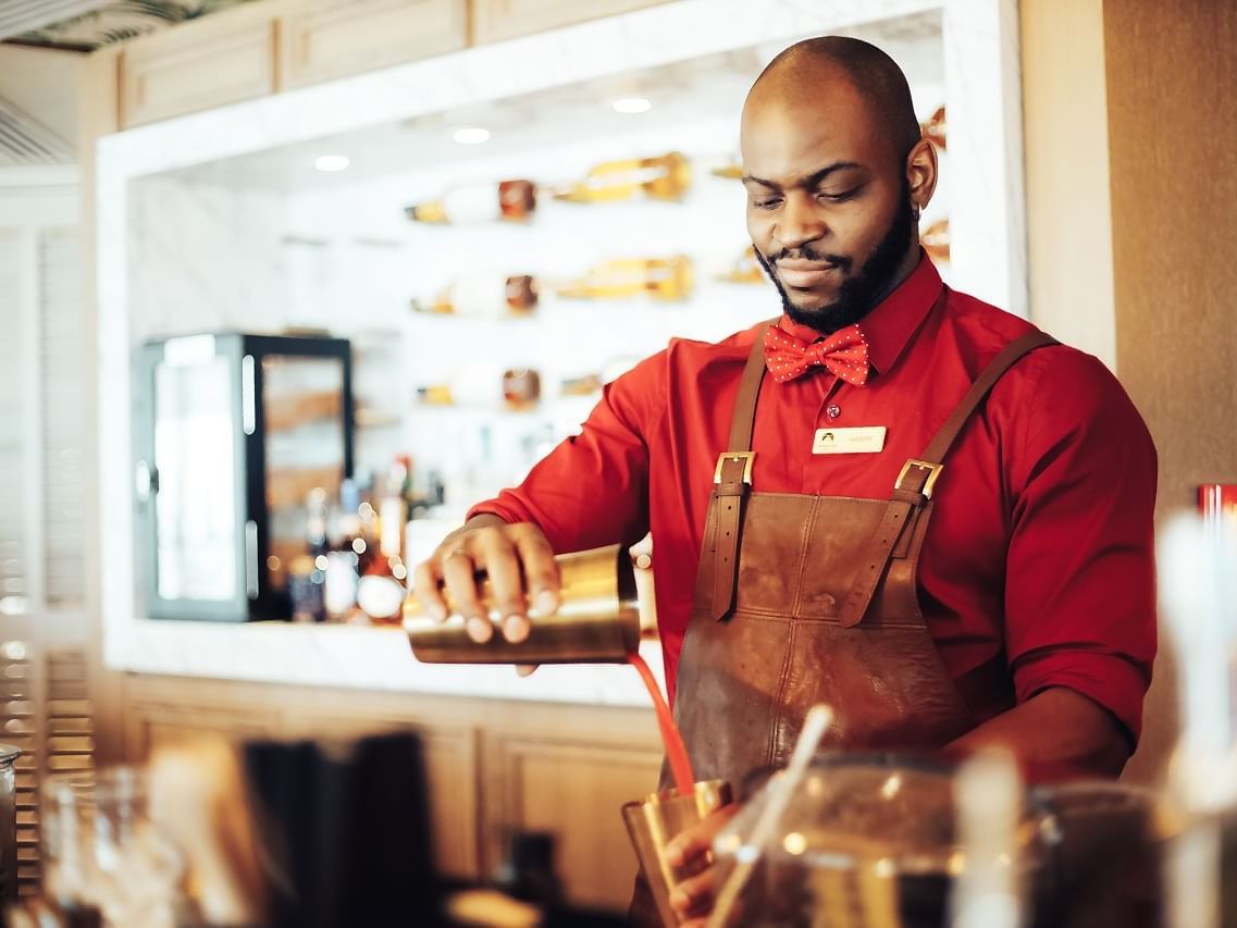 Chef posing while preparing a drink in Pacific Groove Restaurant & Lounge at Paramount Hotel Dubai