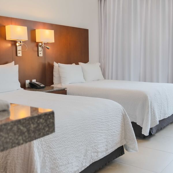 Beds & balcony area in Superior Room 2 Double at Fiesta Inn