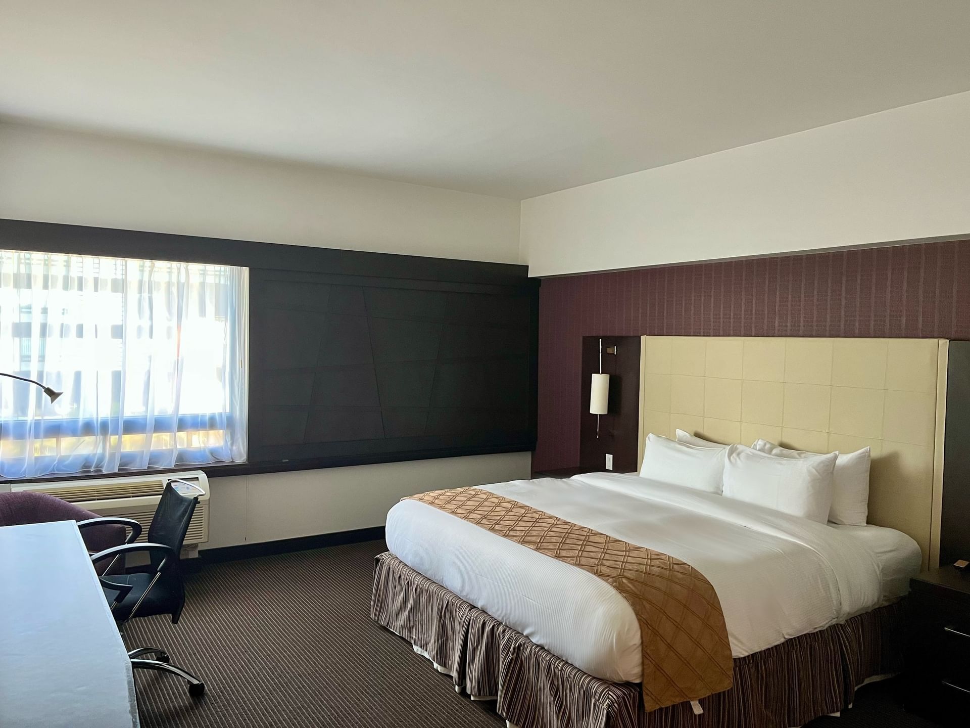 King bed in Standard Room at Ruby Foo's Hotel