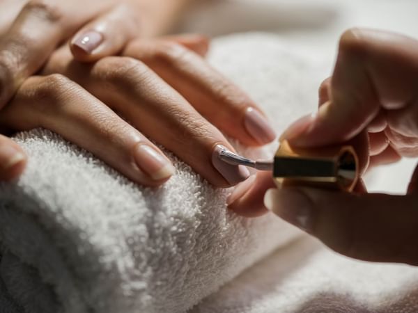 Applying nail polish in a spa at Warwick Le Crystal