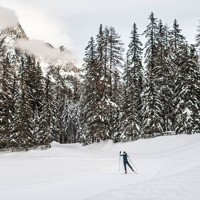 A person riding an ice skateboard in a snowy area near Falkensteiner Hotel Antholz