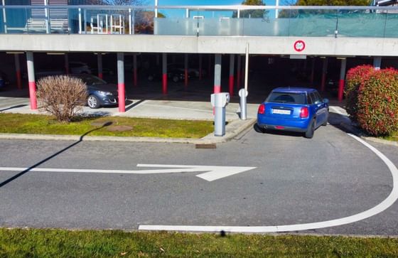 Entrance to a parking garage with directional arrow at Starling Hotels in Lausanne Switzerland