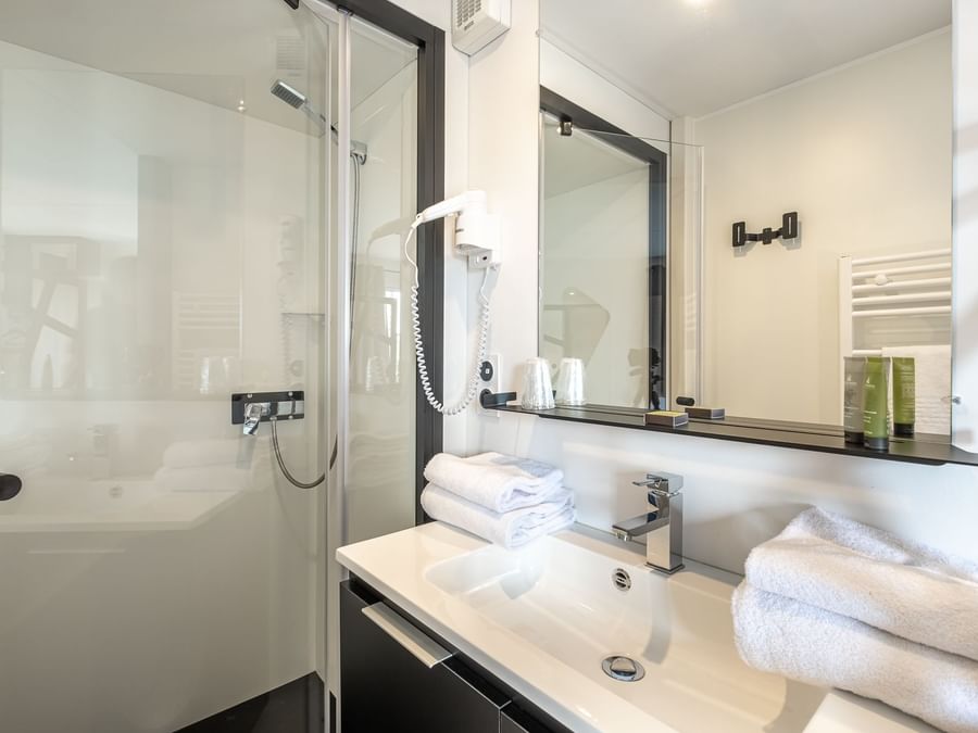Vanity & shower in Ax Hotels at The Originals Hotels