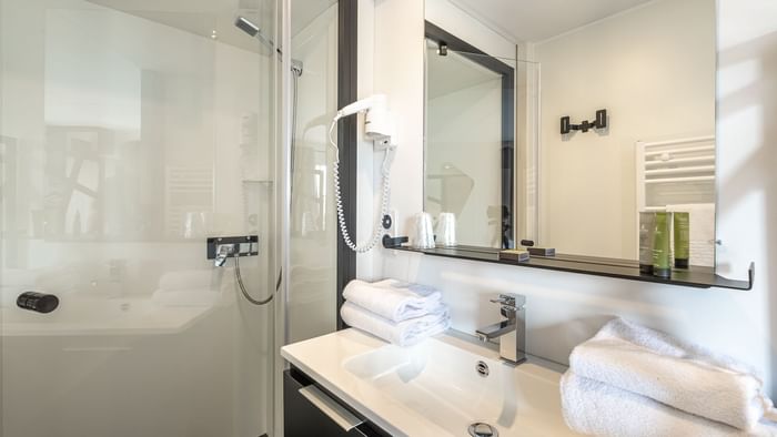 Vanity & shower in Ax Hotels at The Originals Hotels