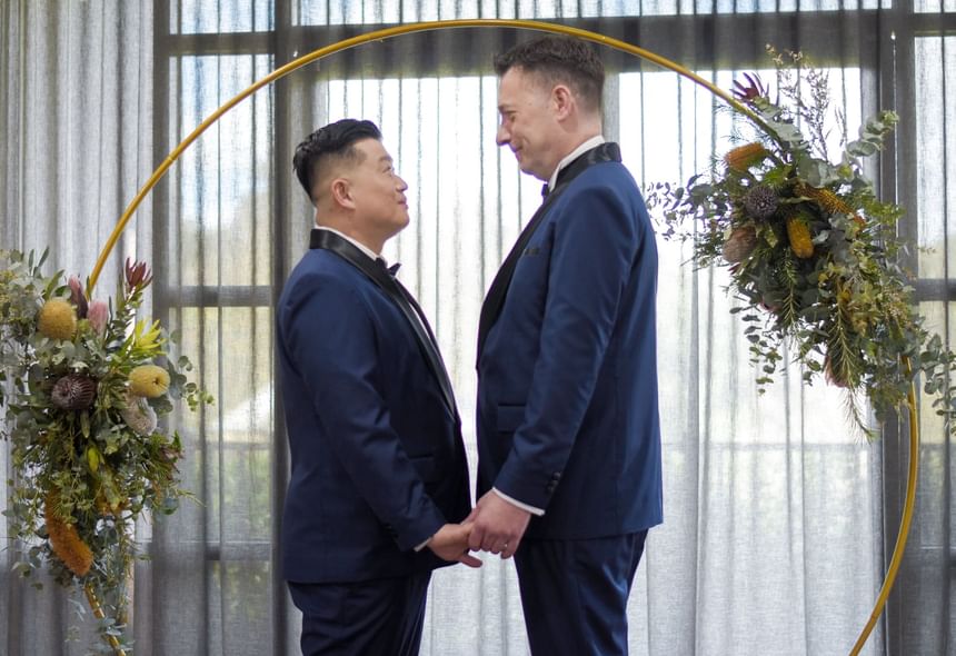 A gay couple looking at each other at Amora Hotel Melbourne