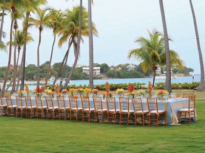 Dining setup with flowers in Copa Gardens at Copamarina