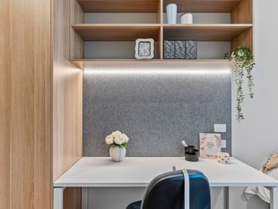 Modern desk with chair and vase in a stylish room at UniLodge Brisbane City.
