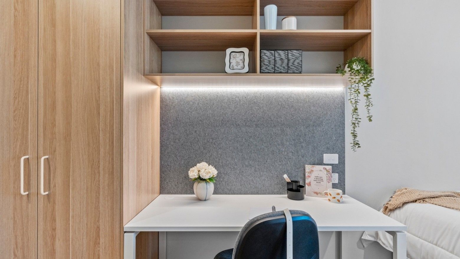 Modern desk with chair and vase in a stylish room at UniLodge Brisbane City.