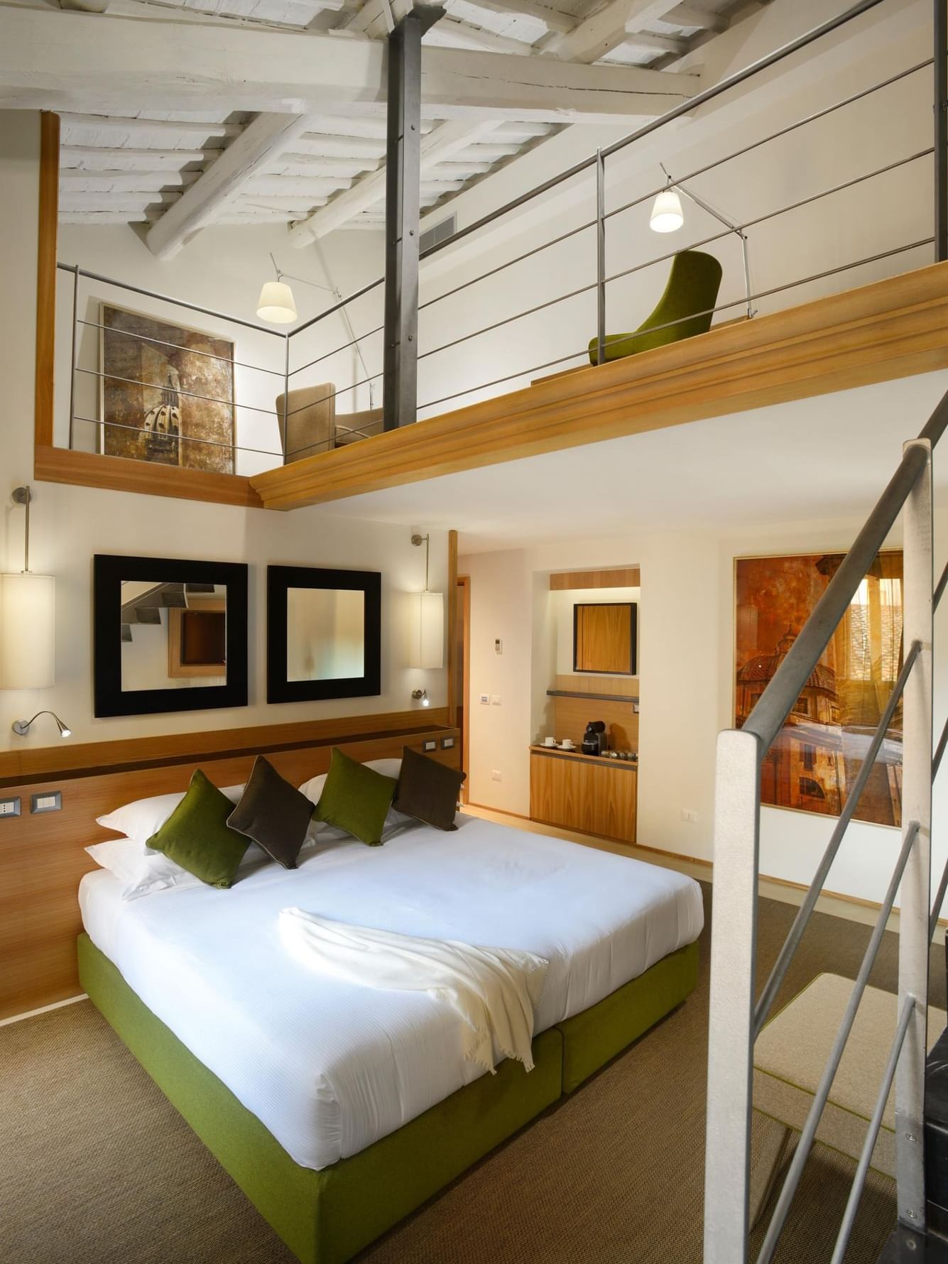 Moncada Suite with a bed and a mezzanine seating area accessed by stairs at Babuino 181