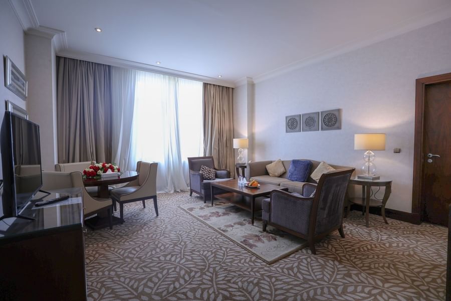 Executive suite living room featuring patterned carpet and comfortable sofas with tables at Saja by Warwick Makkah