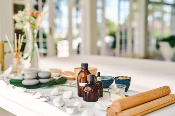 Spa oils, stones, towels, and wellness products arranged at Anchorage By The Sea