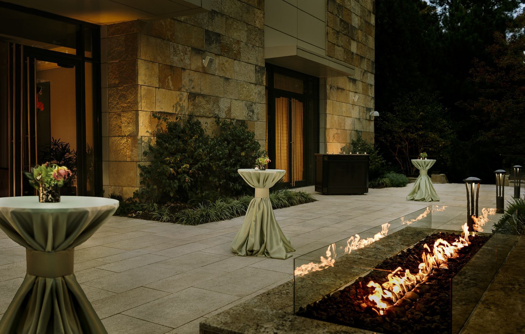 A patio featuring a fire pit & table set up outside the ballroom at Umstead Hotel and Spa