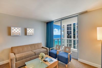 Living area with ocean view balcony at Marenas Resort Miami