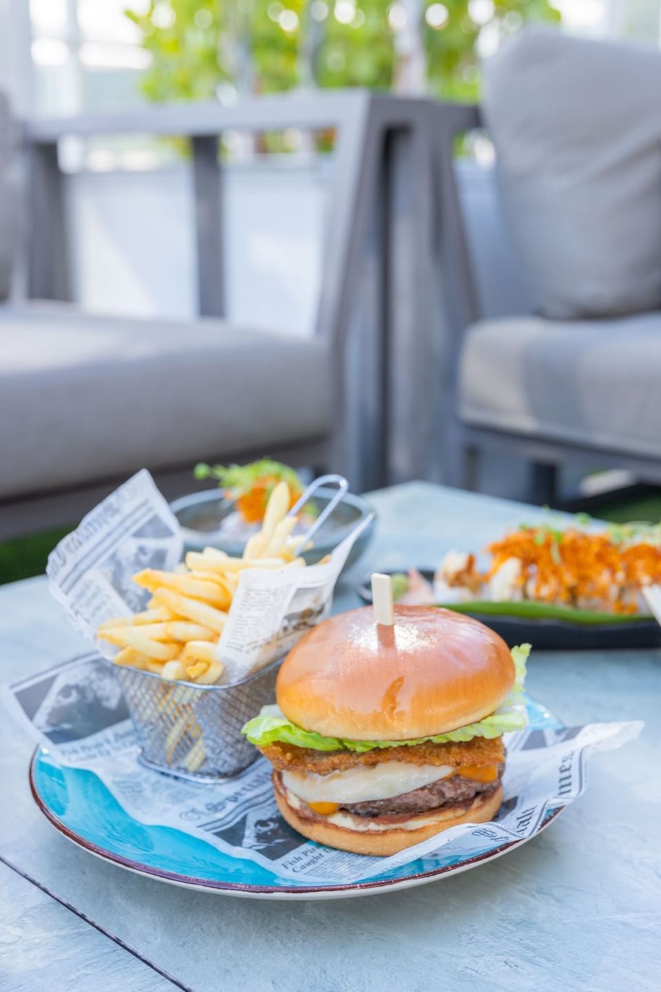 A burger & french-fries served on a stool at Costa Beach Resort