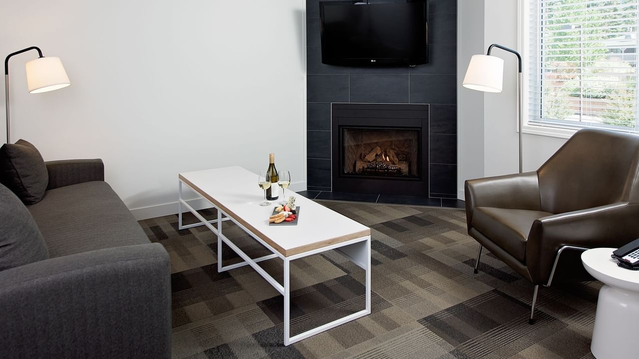 Lounge area of hotel room with fireplace