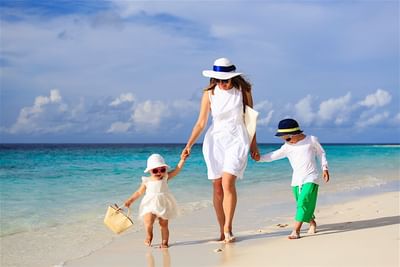Mother and kids strolling along the beach at Accra Hotels & Resorts