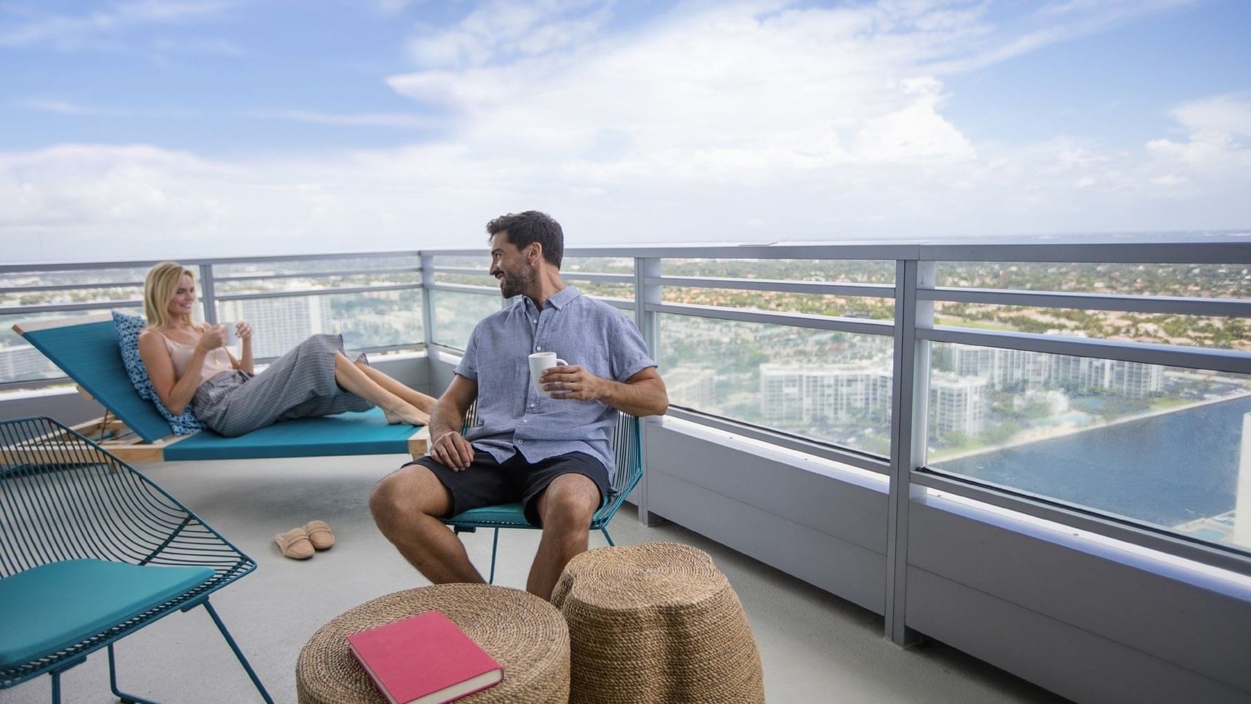 Couple relaxing in Intracoastal Balcony with city view at The Diplomat Resort