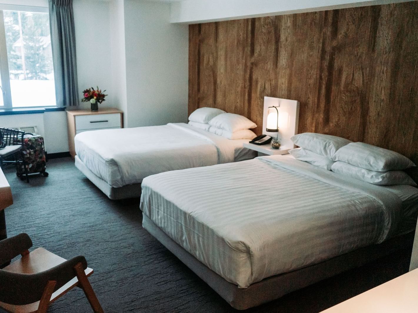 Two beds in hotel room with window