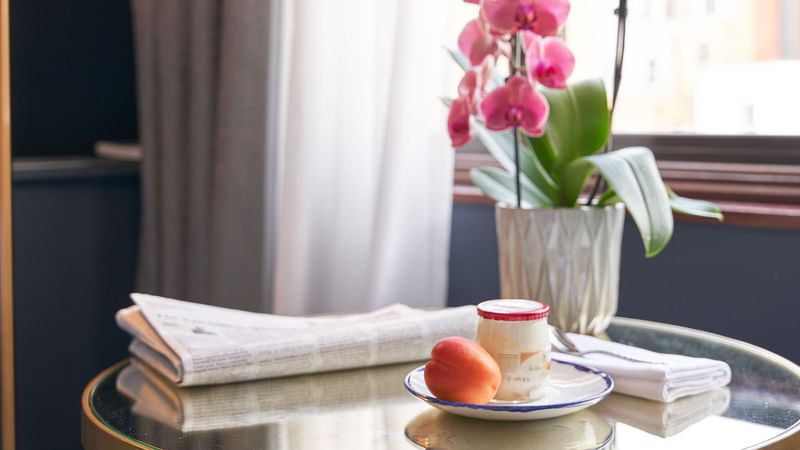 Close-up of a snack & flowers served in Classic Room at The Capital Hotel London