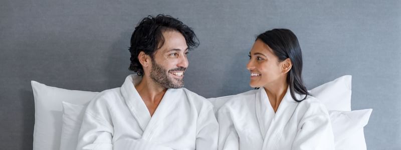 Couple having breakfast on the bed in a room at Pullman Sydney Hyde Park