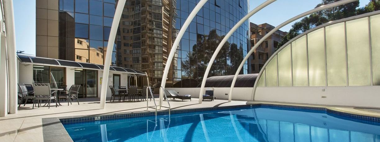 Outdoor swimming pool with clear blue water at Novotel Sydney Parramatta in Parramatta