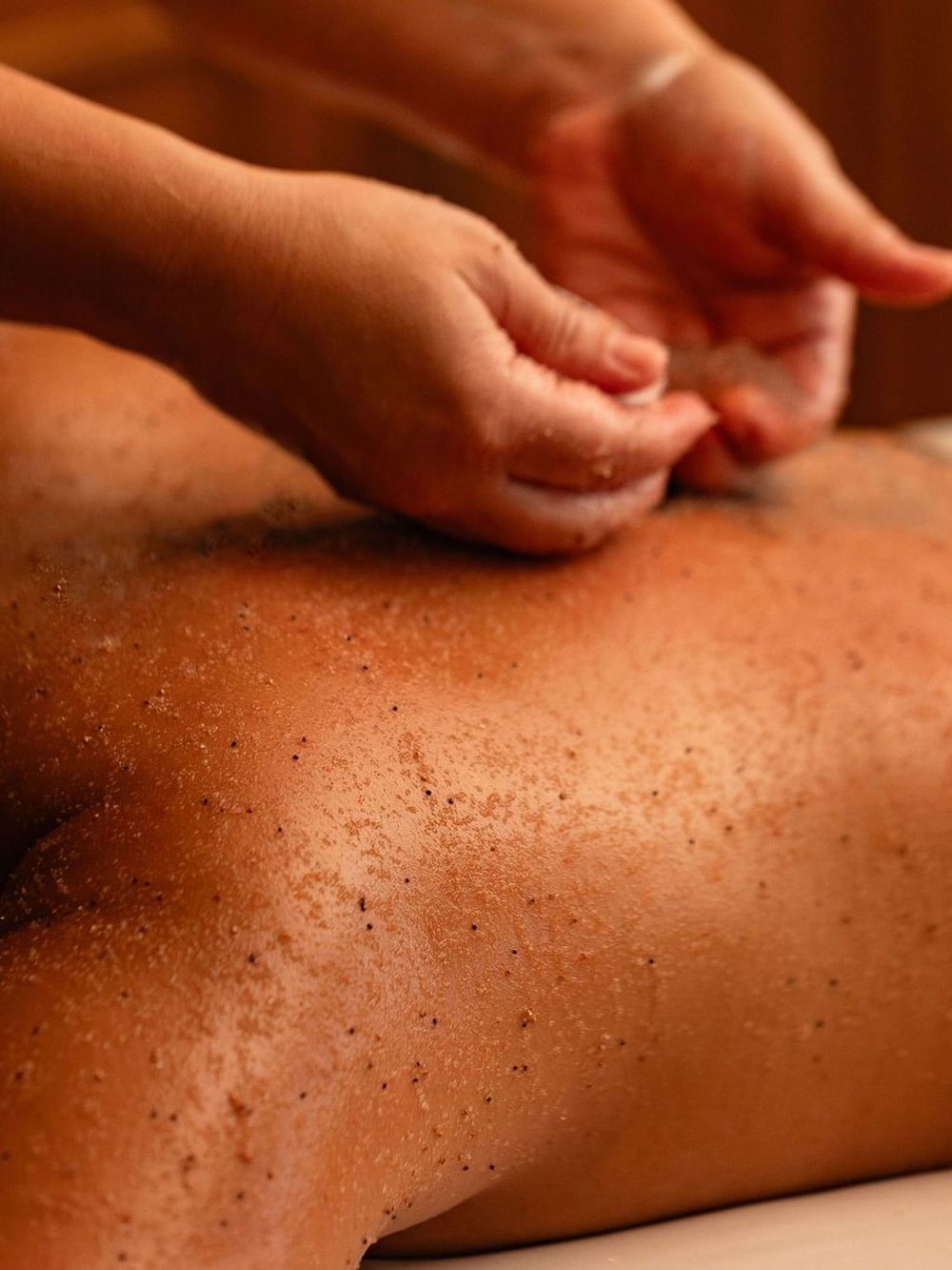 Body Scrub being applied to someone's back