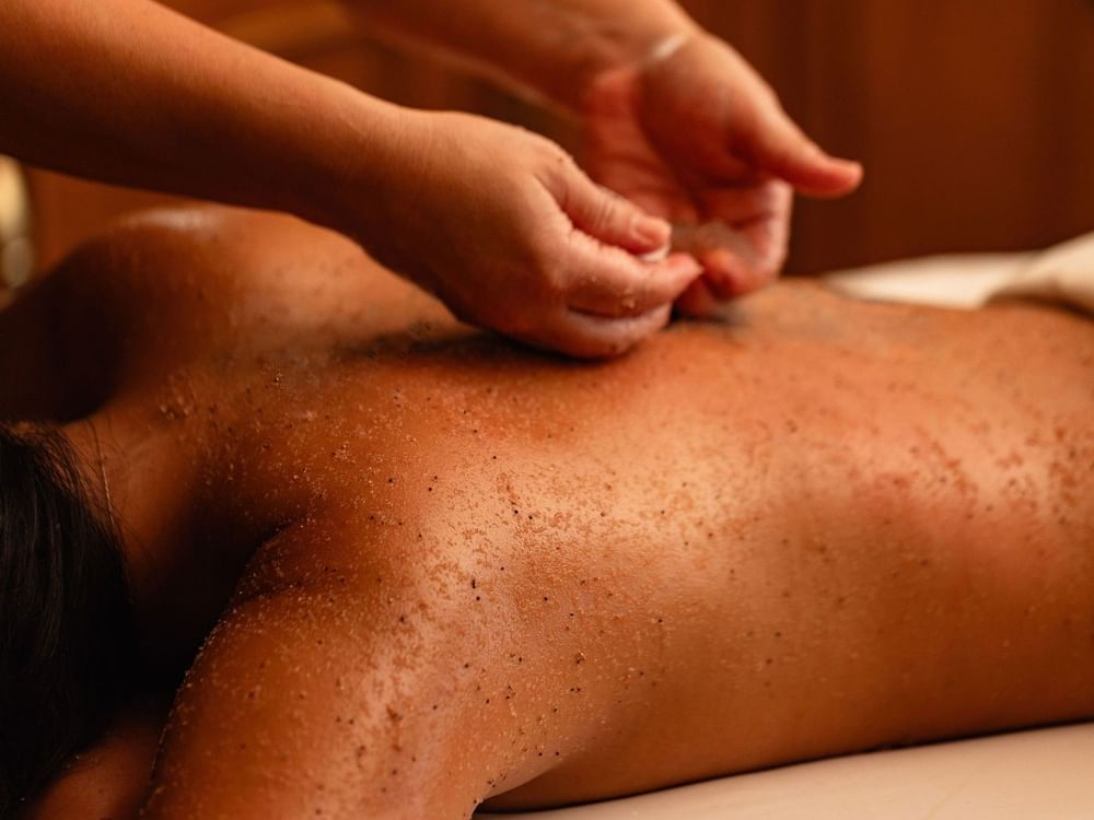 Body Scrub being applied to someone's back