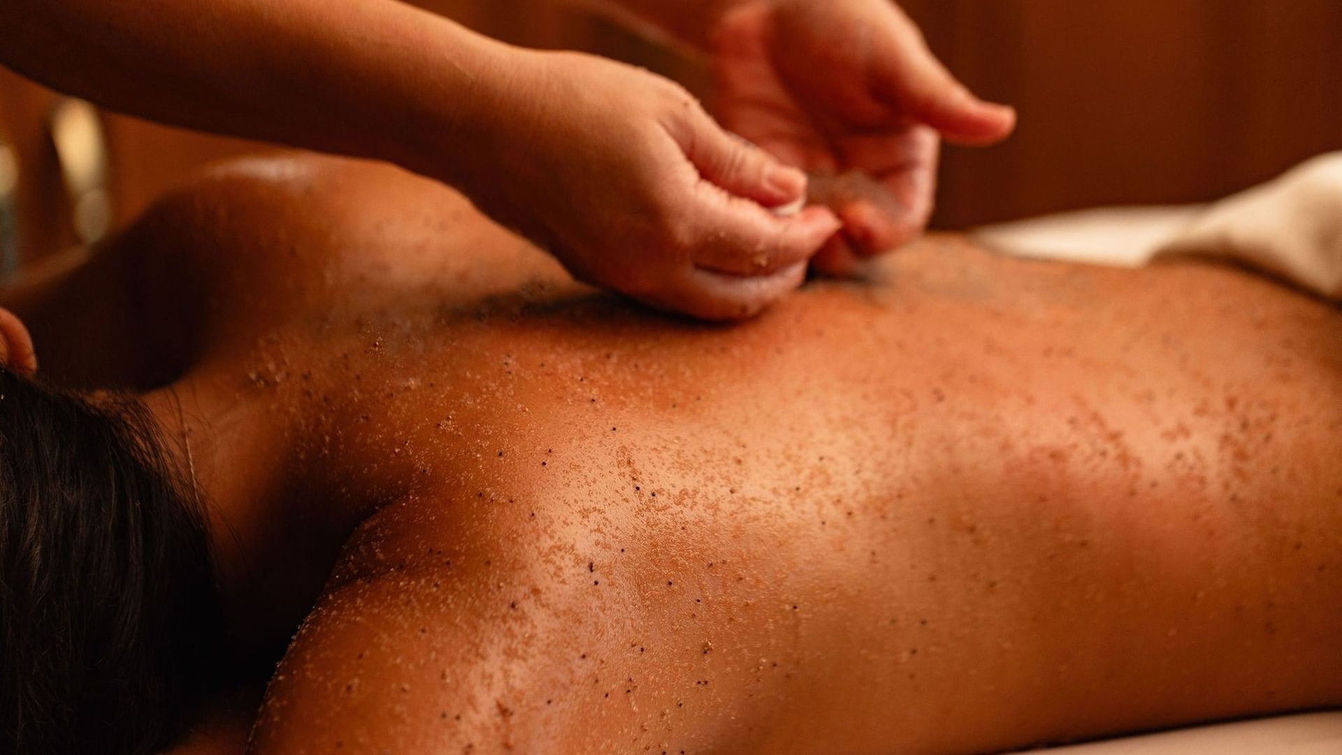 Body Scrub being applied to someone's back