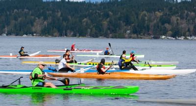 People paddling boats on St. Paddles Day near Alderbrook Resort