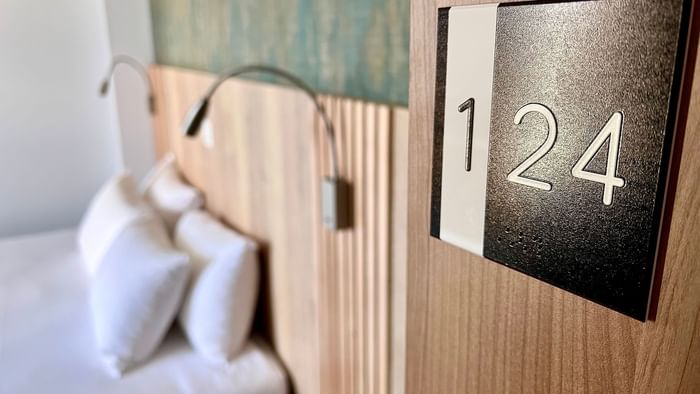 Close-up of 124 room tag in a room at The Originals Hotels
