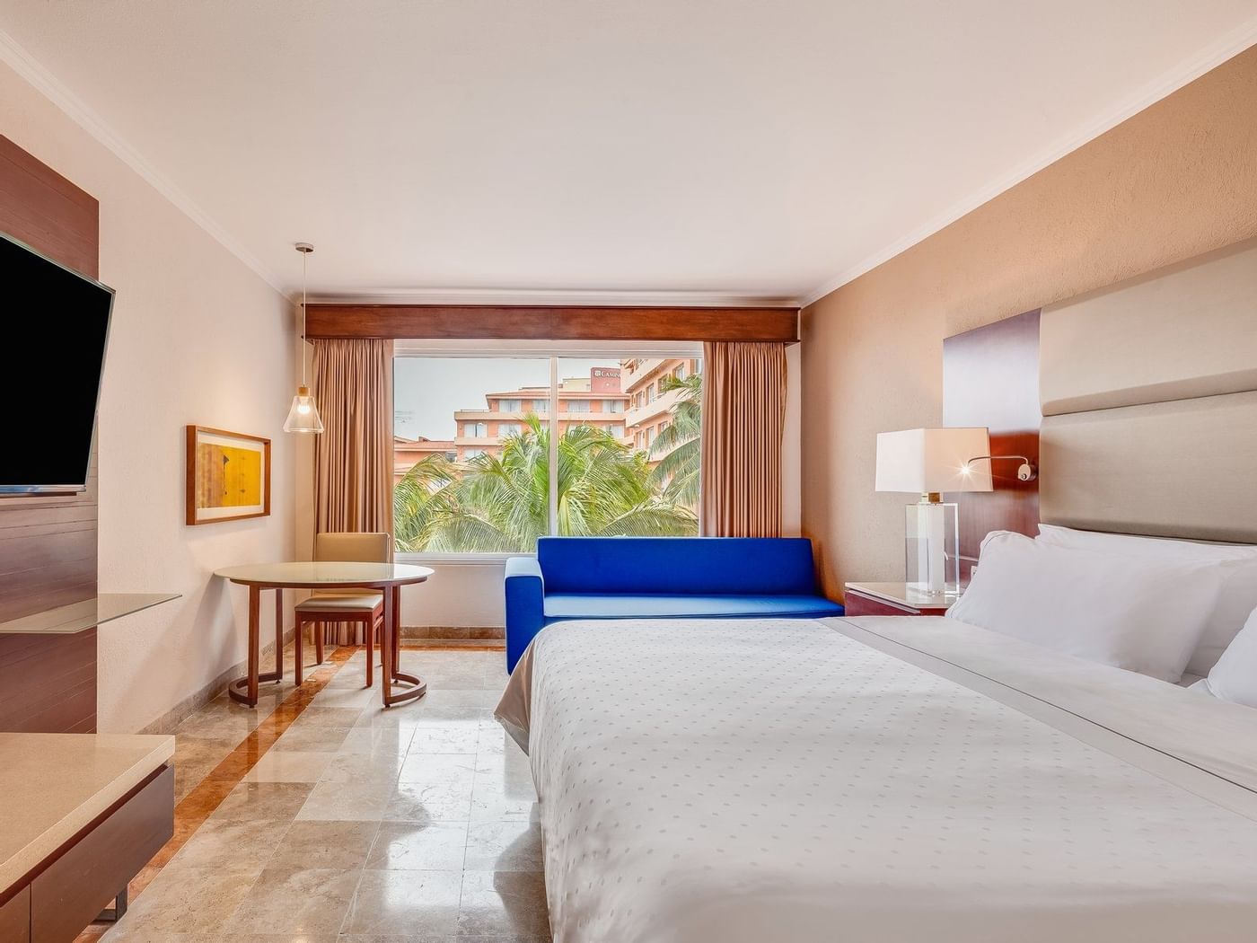 Interior of Deluxe room with king bed at Grand Fiesta Americana