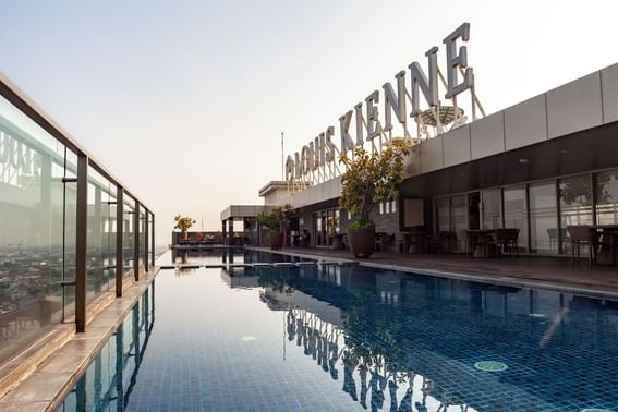 Rooftop pool area with a sign at LK Hotel Simpang Lima
