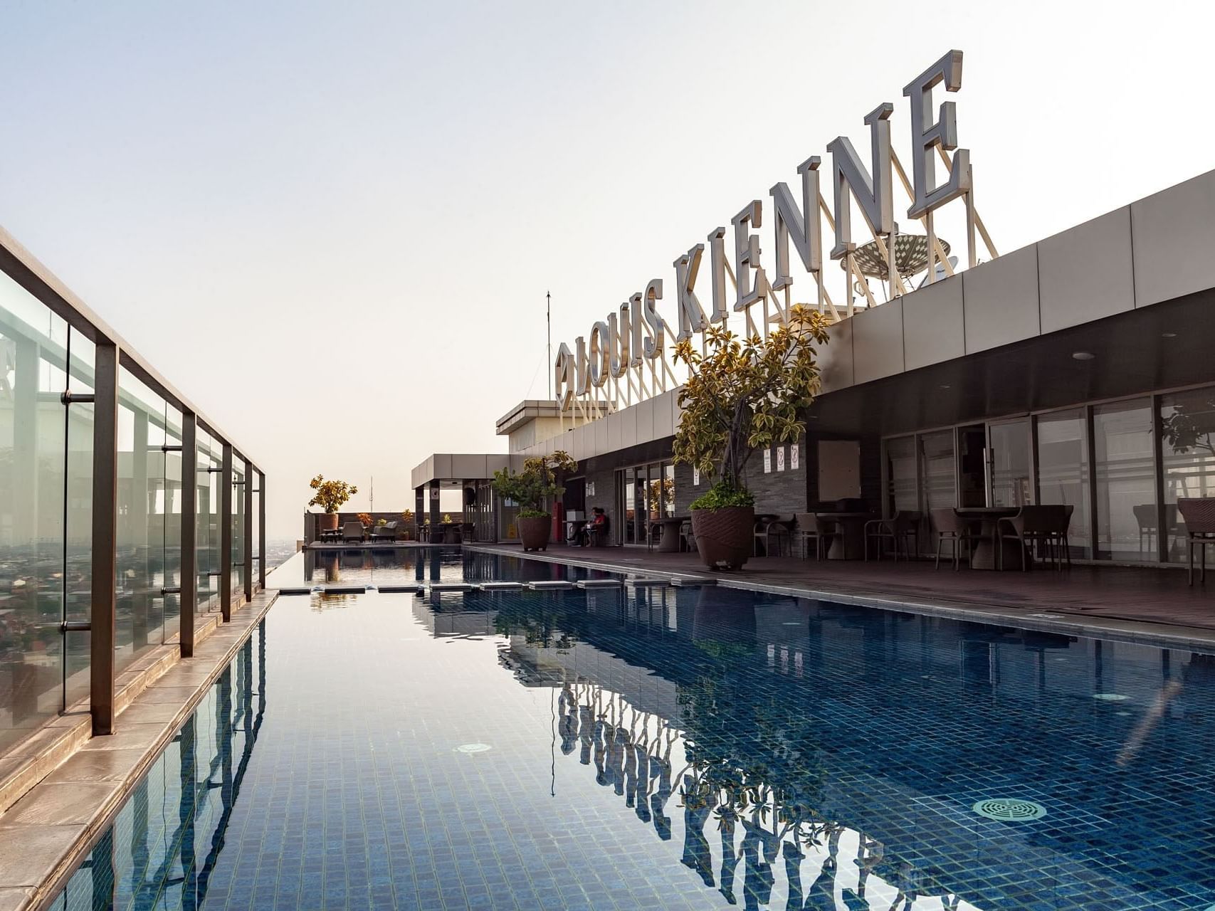 Rooftop pool area with a hotel sign at LK Hotel Simpang Lima