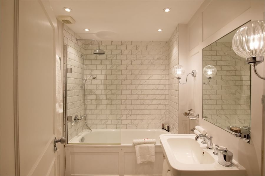 Two Bedroom Apartment bathroom featuring a marble vanity with a bathtub at The Capital Hotel, Apartments and Townhouse