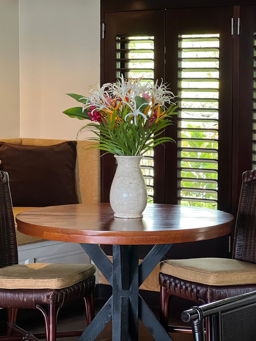 A cozy dining area with tropical decor and wooden table at Warwick Le Lagon - Vanuatu, Efate.