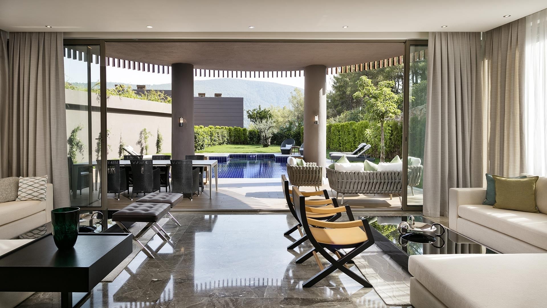 Livingroom area with a pool view in Presidential Villa at Titanic Luxury Collection Bodrum