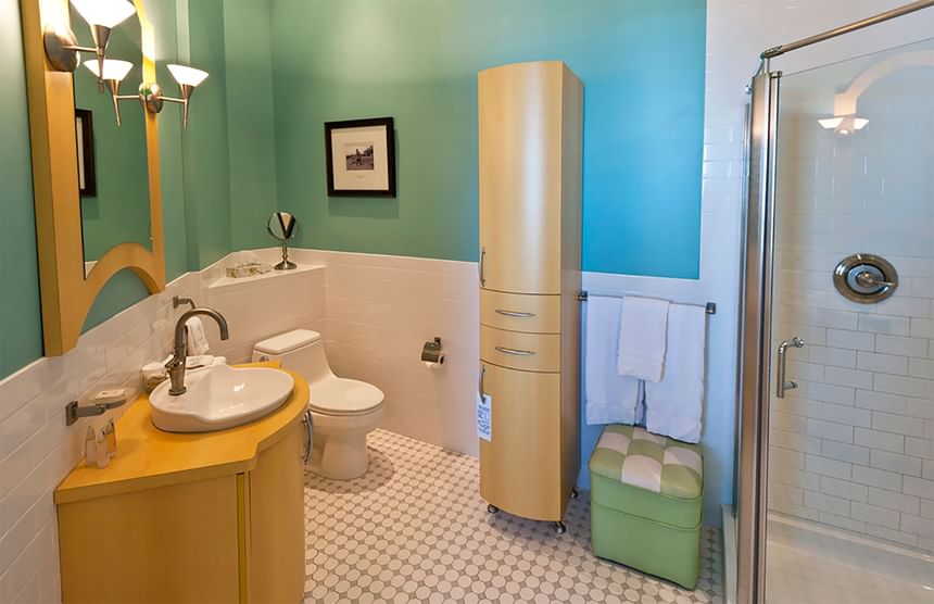 Bathroom interior, vanity, cupboard & shower area in Queen Premiere Sunset in Retro Suites Hotel