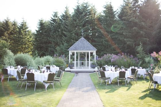 Tables on a lawn by a walkway surrounding a gazebo at Oregon Garden Resort, a top choice of hotels in Silverton