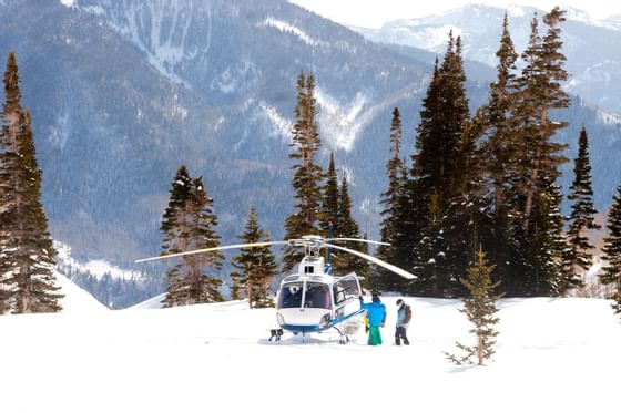 Helicopter on a snowy mountain with a scenic view near Chateaux Deer Valley