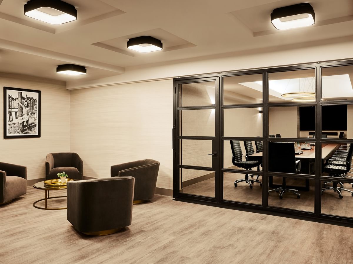 Modern Executive Boardroom with glass-walled conference space and lounge seating at Gansevoort Meatpacking NYC in New York