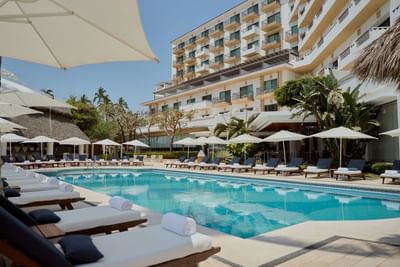 Outdoor pool area with loungers at Villa Premiere Boutique Hotel & Romantic Getaway