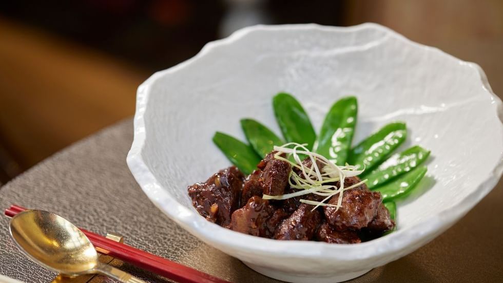 Glistening cubes of beef with green peas in a restaurant at Crown Hotels Perth