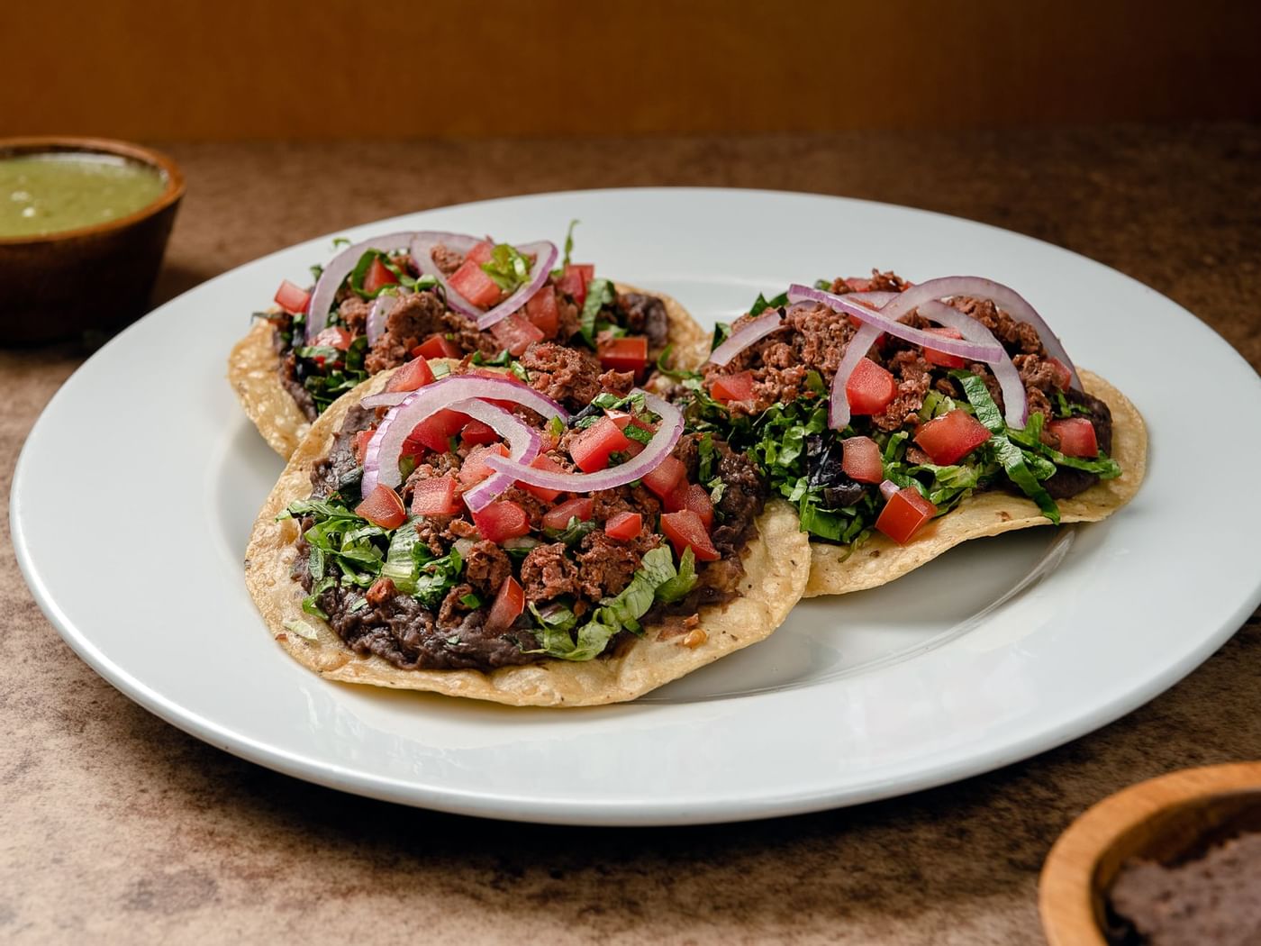 Three beef tacos on a plate served at One Hotels