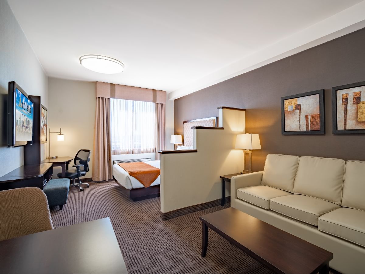 Sofa with a coffee table in a Diamond Studio Suite at Acclaim Hotel Calgary