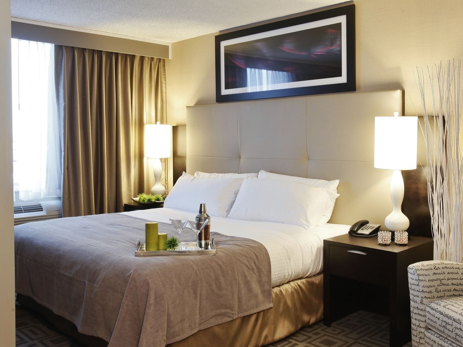 a chair and bed in a hotel room