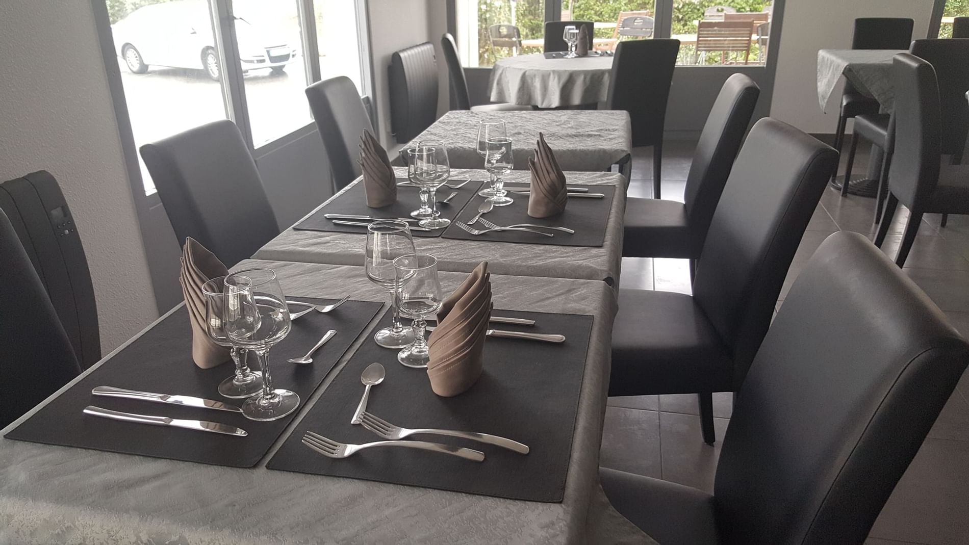 Chairs & tables with cutlery, glasses at The Originals Hotels