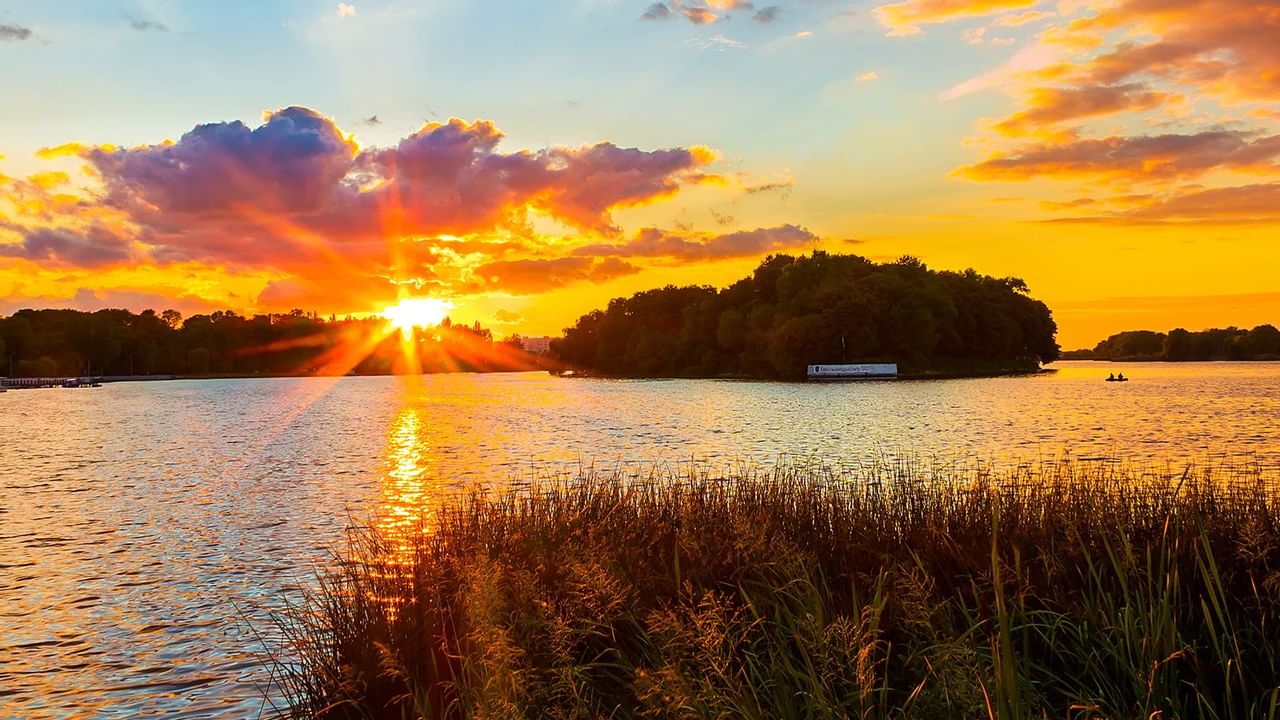 Sunset over a river near Coast Grimshaw Hotel & Suites
