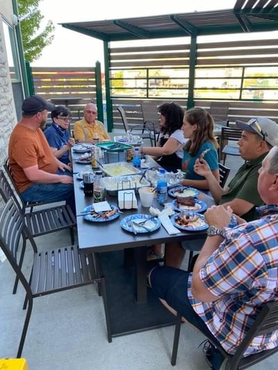 Group of friends having breakfast on the patio at Boothill Inn & Suites