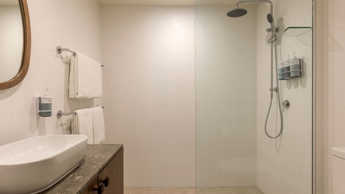 Modern bathroom with white vessel sink, walk-in shower, and neutral tones at Novotel Sunshine Coast, Twin Waters.