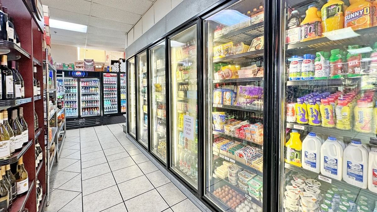 a convenience store with refrigerators and shelves stocked with various products